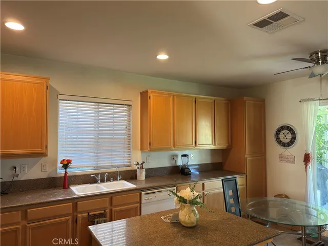 a kitchen with granite countertop a sink a stove and a window