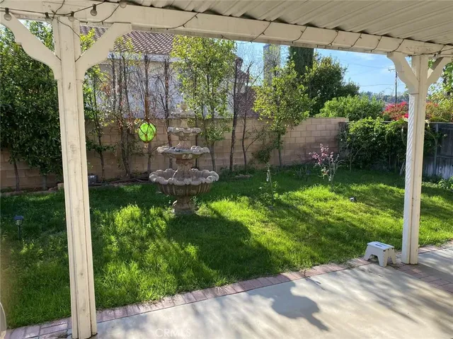 a backyard of a house with a garden and outdoor seating
