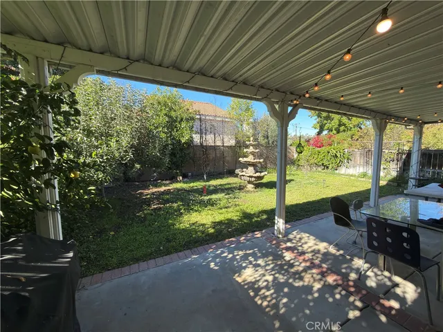 a view of a patio with table and chairs potted plants with wooden floor