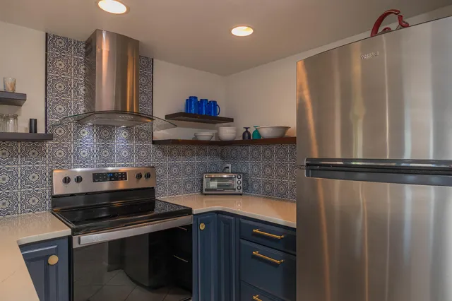a kitchen with stainless steel appliances a sink and a cabinets