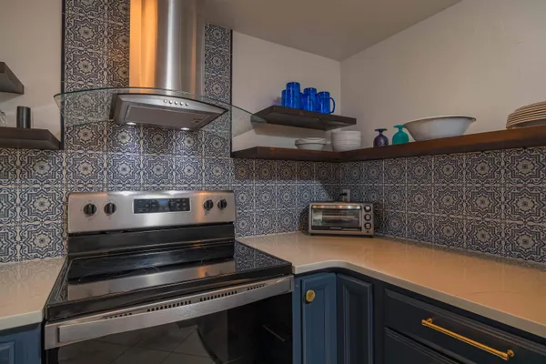 a stove top oven sitting inside of a kitchen