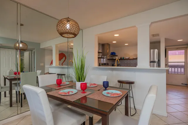 a view of a dining room with furniture and chandelier