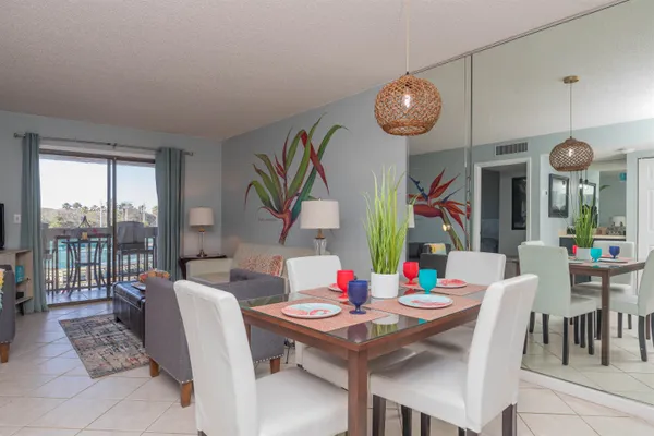 a view of a dining room with furniture large windows and wooden floor