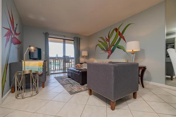 a living room with furniture and a floor to ceiling window