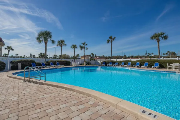 a view of a swimming pool with a table and chairs
