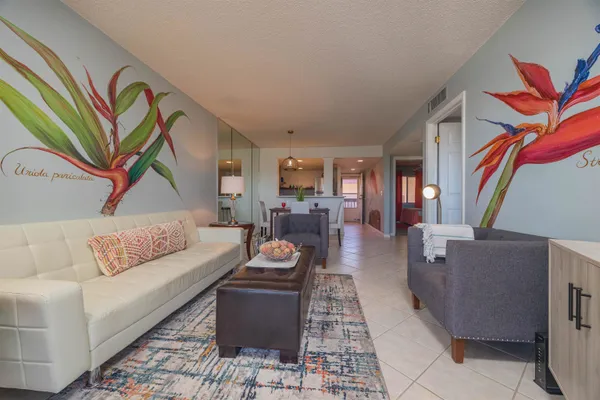 a living room with furniture and a painting