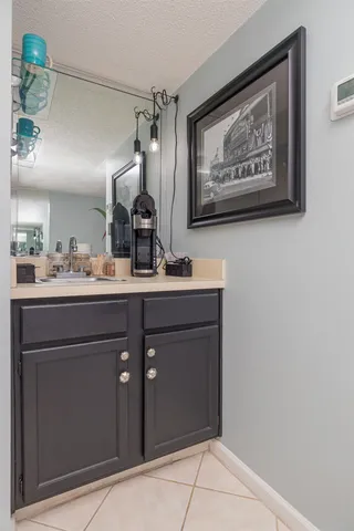 a bathroom with a sink mirror and vanity