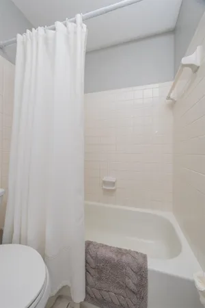 a bathroom with a shower curtain and toilet