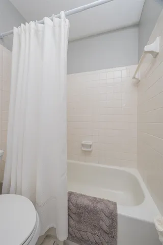a bathroom with a shower curtain and toilet