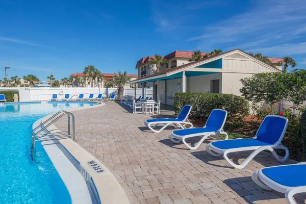 a view of a patio with couches chairs and a table and chairs