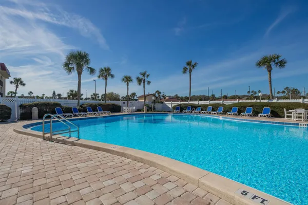 a view of a swimming pool and lounge chairs