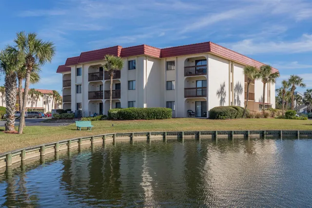 a view of a house with pool and sitting area