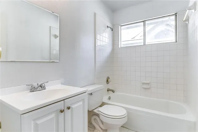 a bathroom with a sink mirror toilet and bathtub