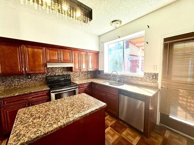 a kitchen with a stove and a sink