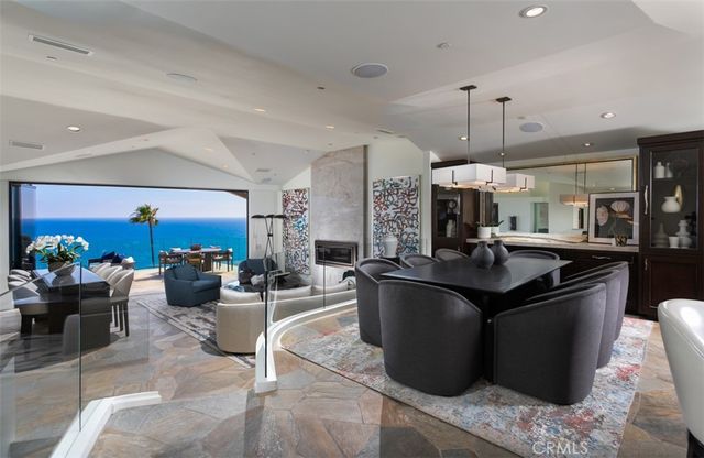 a kitchen with stainless steel appliances kitchen island granite countertop a sink and a large window