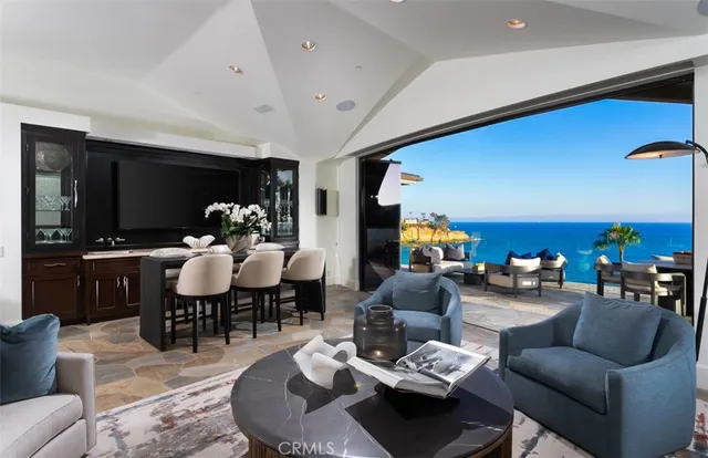 a living room with furniture kitchen view and a flat screen tv