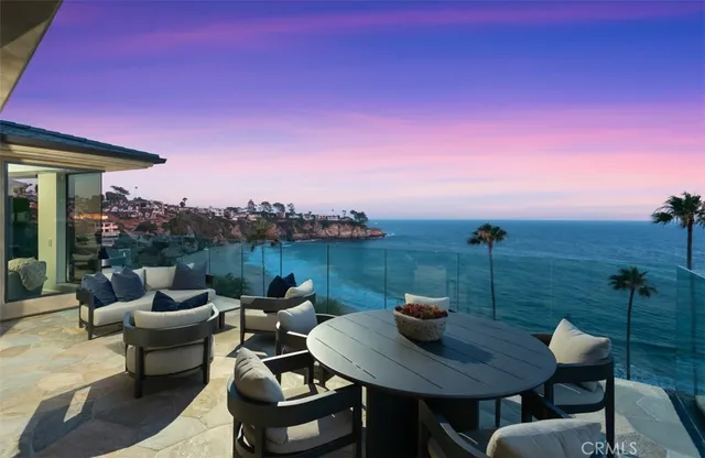 a view of a roof deck with table and chairs a barbeque grill with dining table and chairs