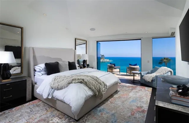 a spacious bedroom with a bed and a couch