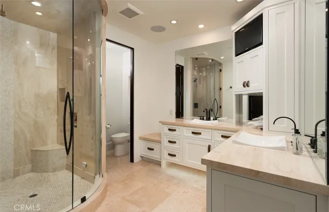 a bathroom with a double vanity sink a mirror and shower