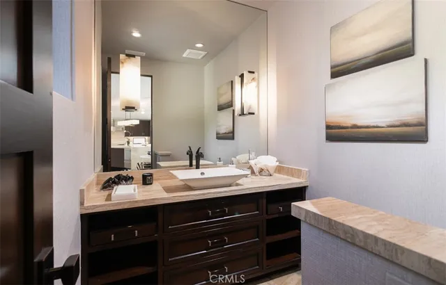 a bedroom with a bed and a view of living room