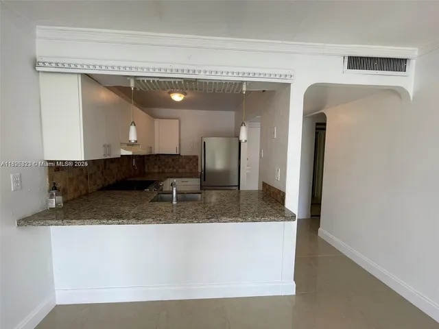 a bathroom with a granite countertop sink mirror and vanity