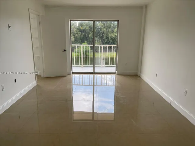a view of empty room with floor to ceiling window