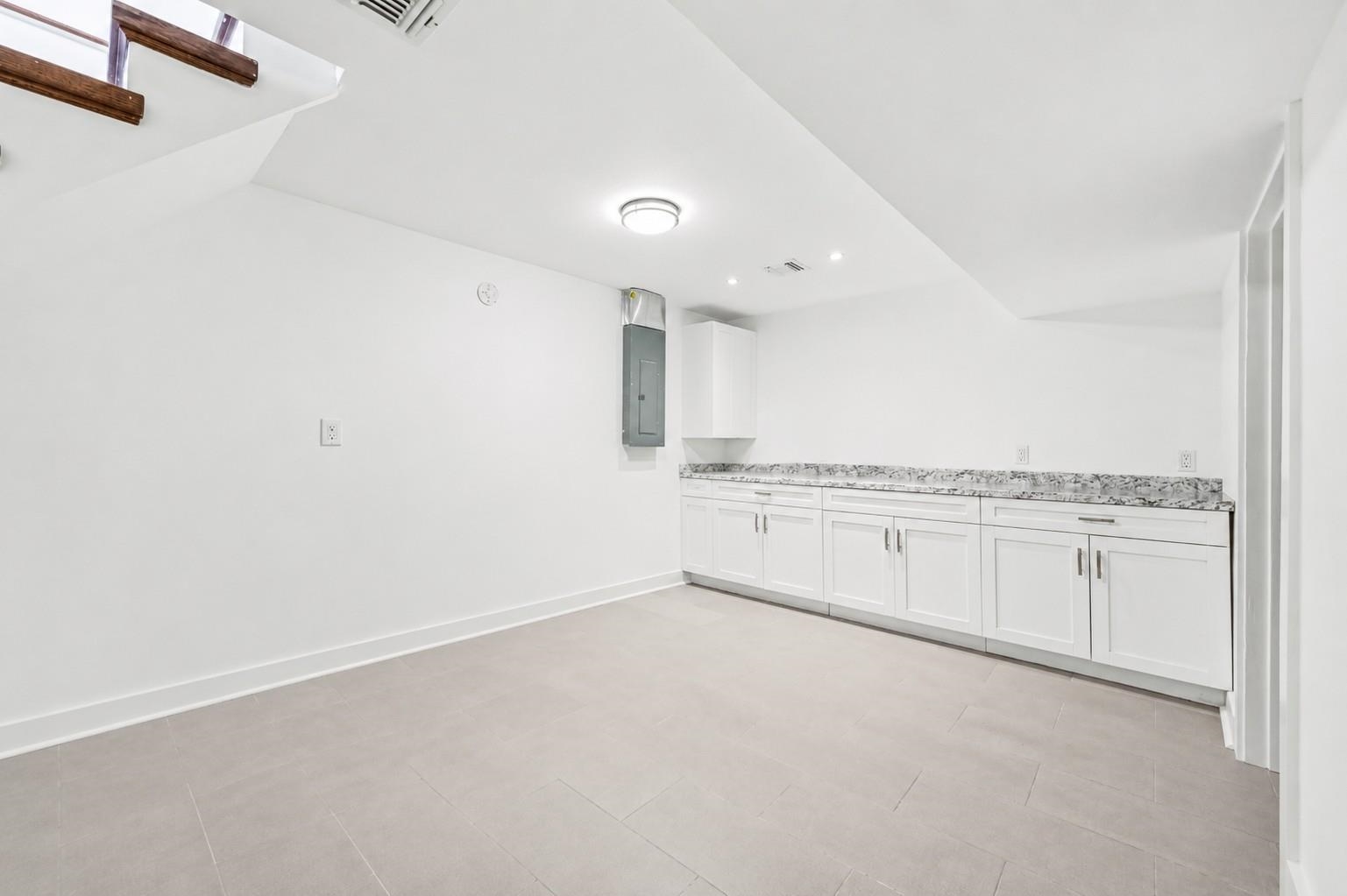 107 Mountain Road Jersey City, NJ 07307 - Photo 32 of 41 an empty room with white kitchen