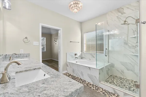 a bathroom with a tub sink and mirror