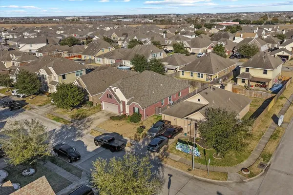 an aerial view of a house with a yard