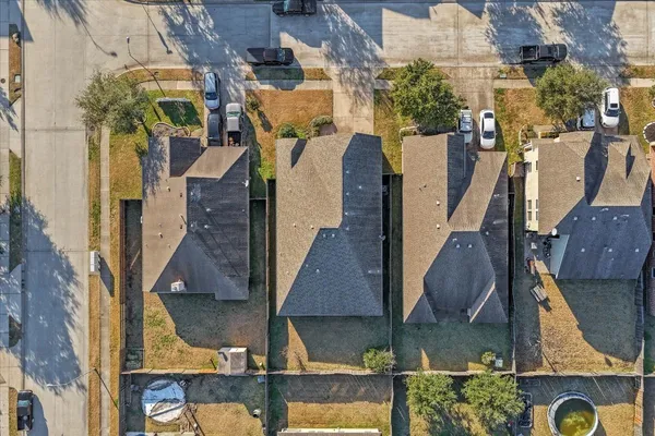 an aerial view of residential houses with outdoor space