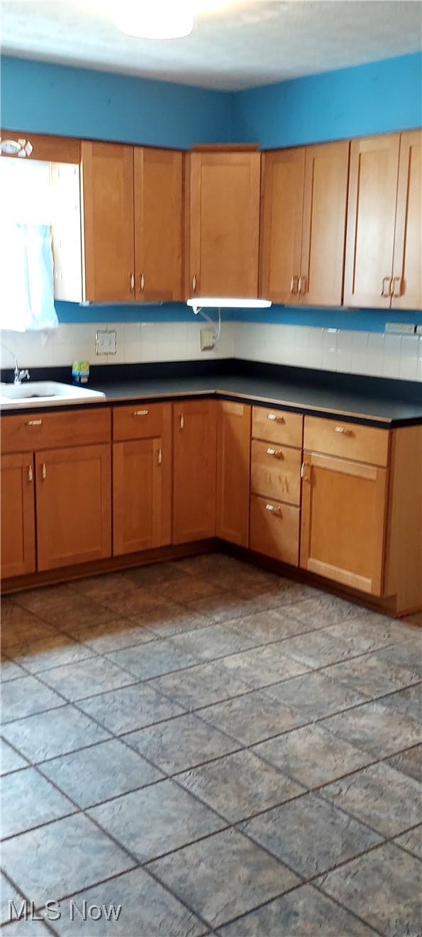 564 Stephens Road Akron, OH 44312 - Photo 3 of 13 Kitchen with a sink and dark countertops.