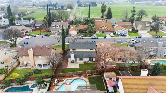 an aerial view of a house with a swimming pool