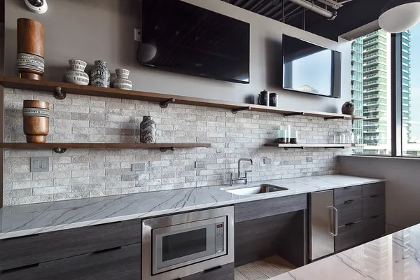 a kitchen with stainless steel appliances granite countertop a sink stove and microwave