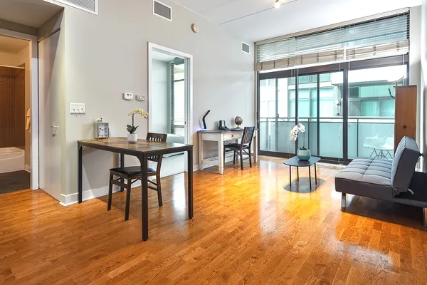 a view of a dining room with furniture window and wooden floor