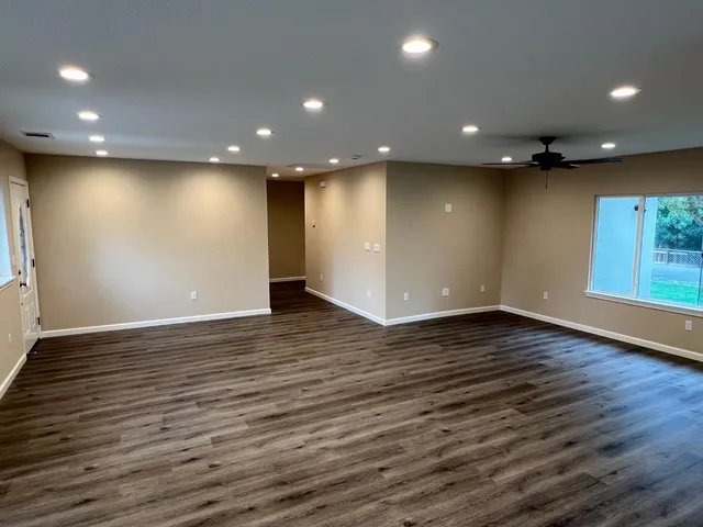 a view of a hallway with wooden floor
