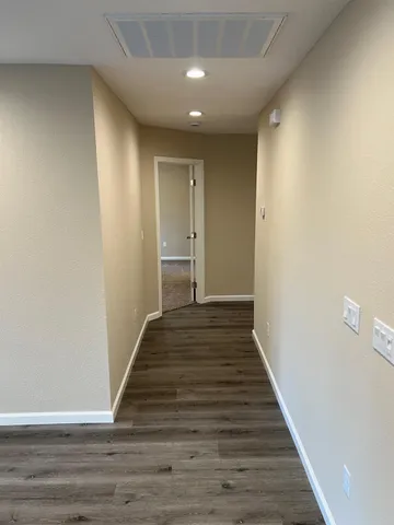 an empty room with a ceiling fan and a window