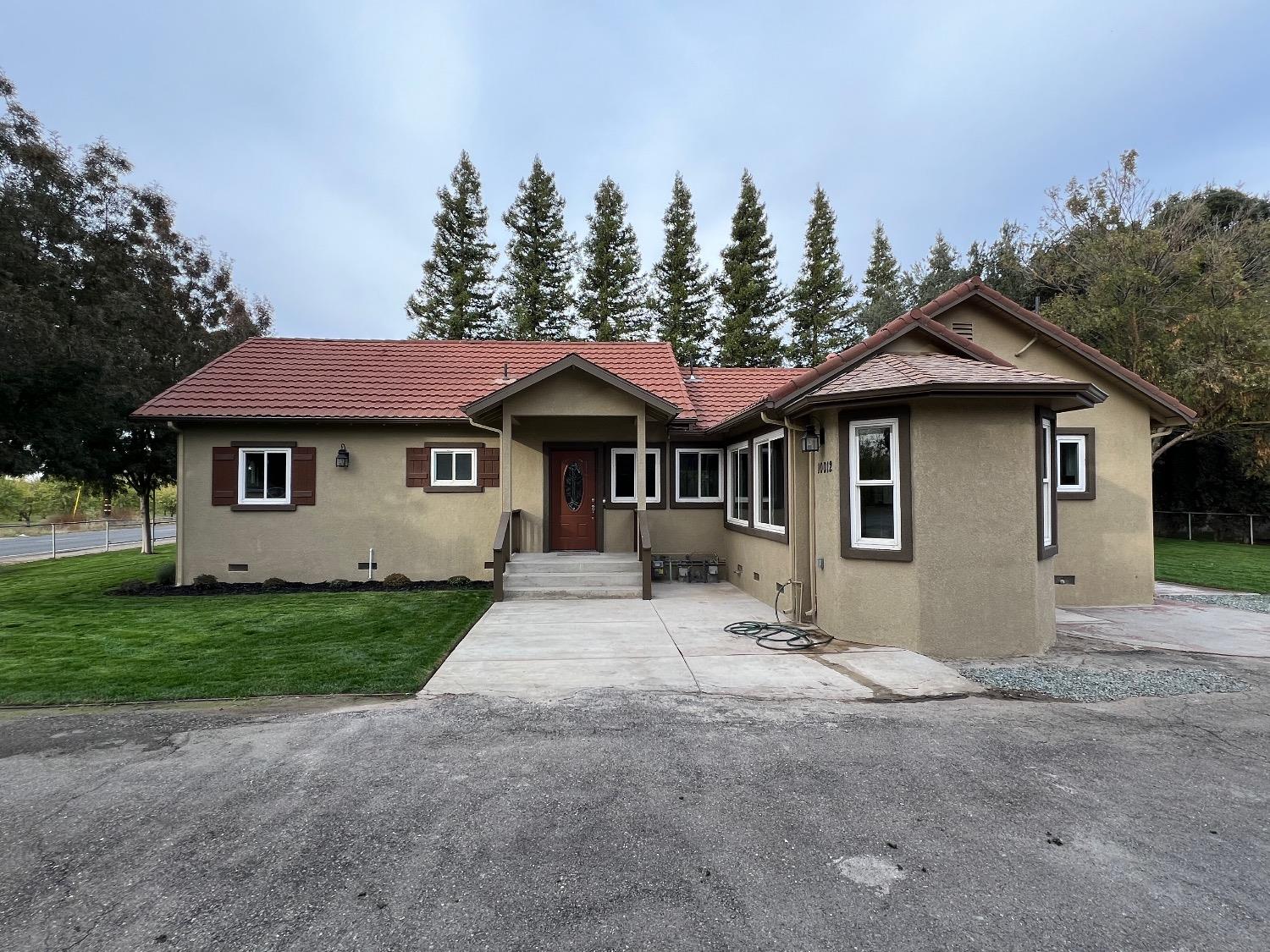 10016 South Priest Road French Camp, CA 95231 - Photo 2 of 63 a front view of a house with a garden and yard