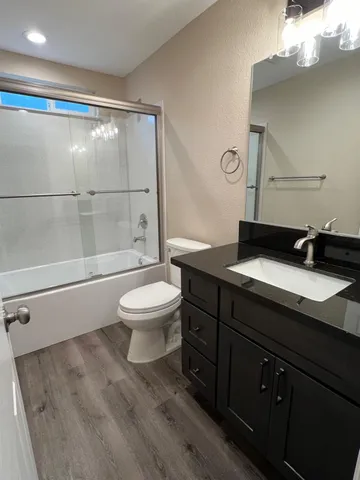 a view of kitchen with kitchen island granite countertop cabinets and wooden floor