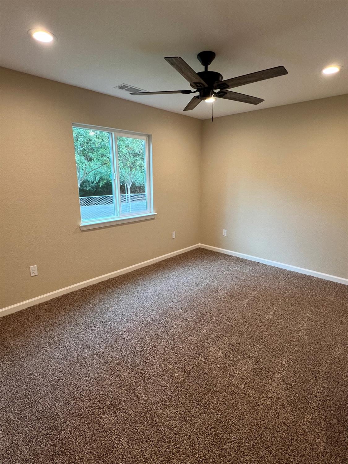 10016 South Priest Road French Camp, CA 95231 - Photo 23 of 63 a view of a livingroom with a ceiling fan and a window