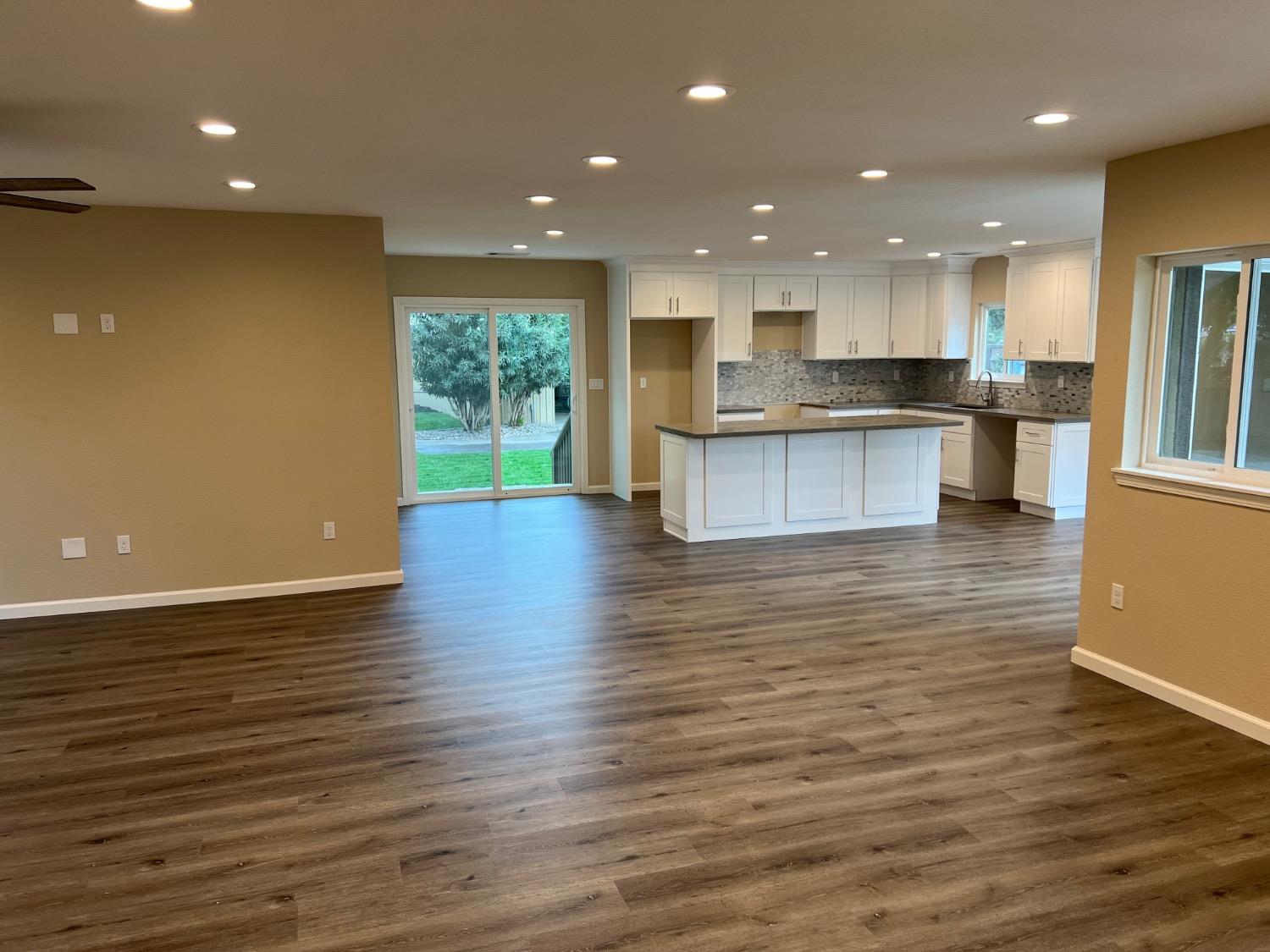 10016 South Priest Road French Camp, CA 95231 - Photo 24 of 63 a view of kitchen with kitchen island granite countertop cabinets and wooden floor