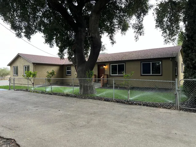 a view of kitchen and kitchen with stainless steel appliances wooden floor