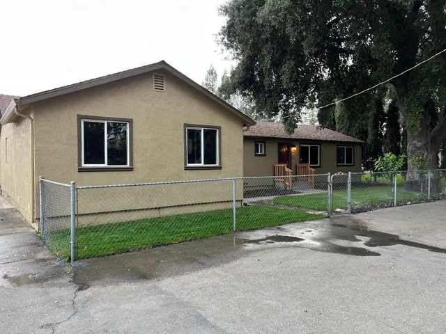 a large kitchen with stainless steel appliances granite countertop a large counter top and wooden floors