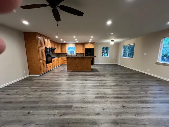 an empty room with wooden floor and entrance