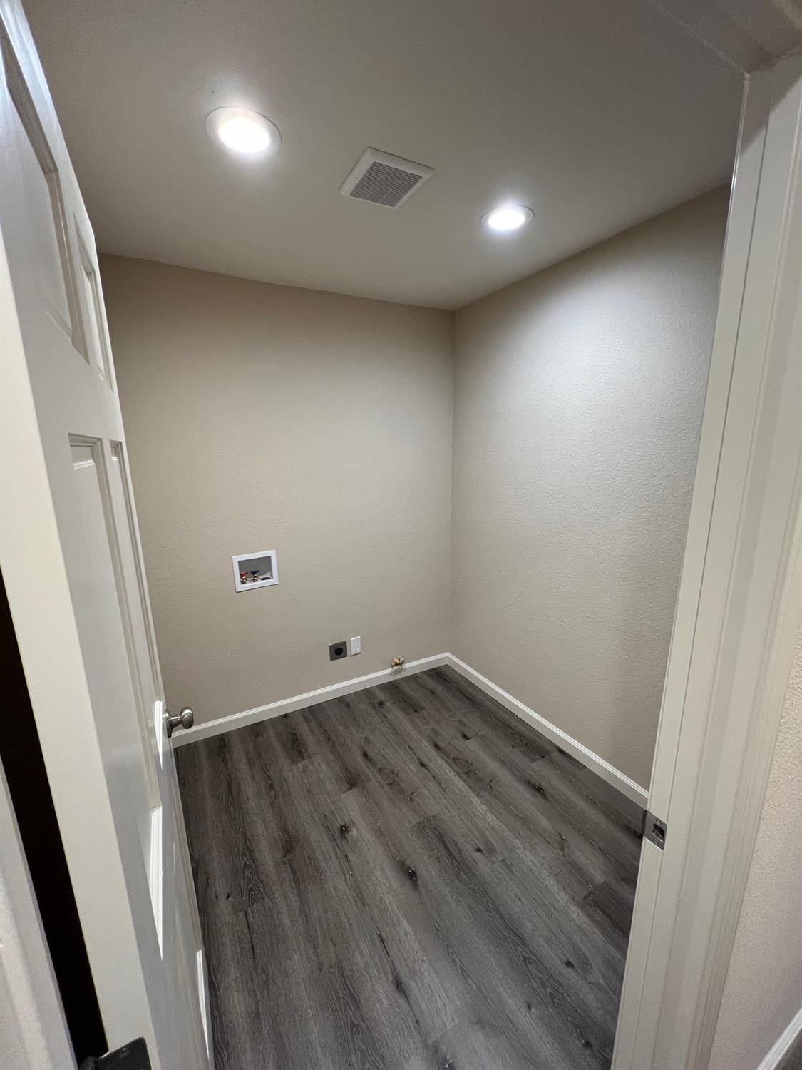 10016 South Priest Road French Camp, CA 95231 - Photo 34 of 63 an empty room with wooden floor and entrance