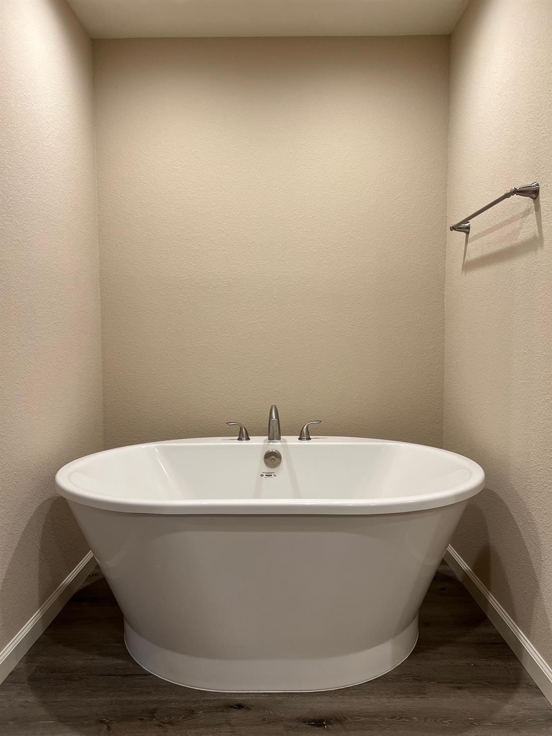 10016 South Priest Road French Camp, CA 95231 - Photo 38 of 63 a white and white tub sitting in a bathroom