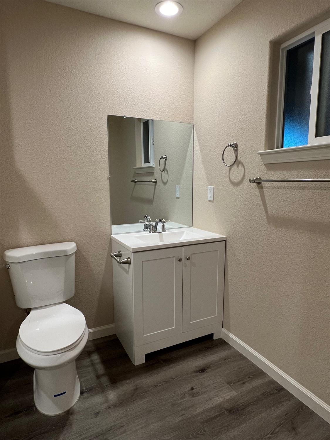 10016 South Priest Road French Camp, CA 95231 - Photo 45 of 63 a bathroom with a toilet sink and mirror