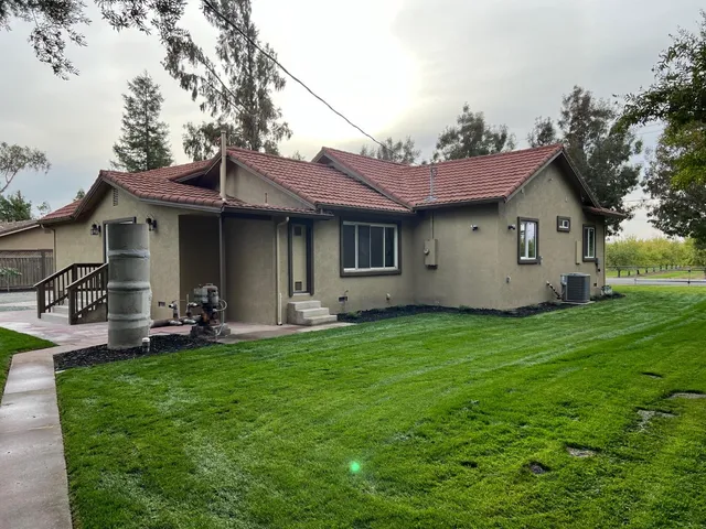 a view of a house with backyard sitting area and garden