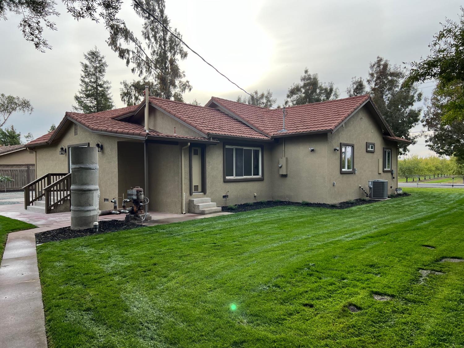 10016 South Priest Road French Camp, CA 95231 - Photo 6 of 63 a view of a house with backyard sitting area and garden