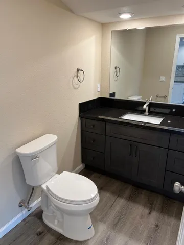 a bathroom with a toilet a sink and mirror
