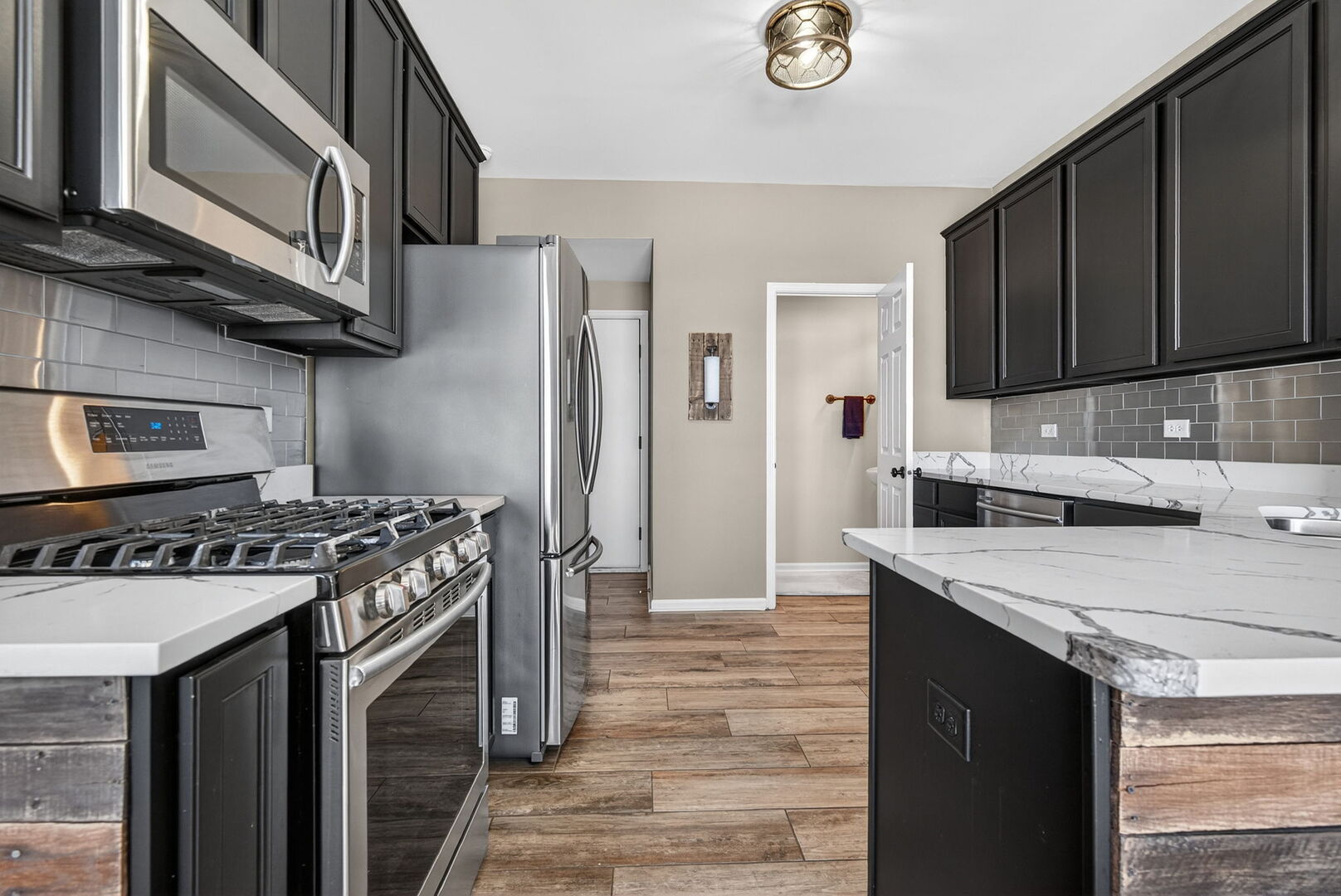 15238 Kenmare Circle Manhattan, IL 60442 - Photo 5 of 29 a kitchen with stainless steel appliances granite countertop a stove and a refrigerator